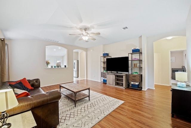 living room featuring hardwood / wood-style flooring and ceiling fan