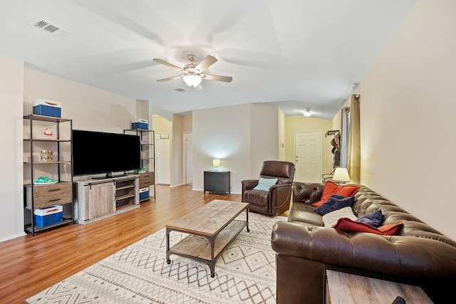 living room featuring ceiling fan and wood-type flooring