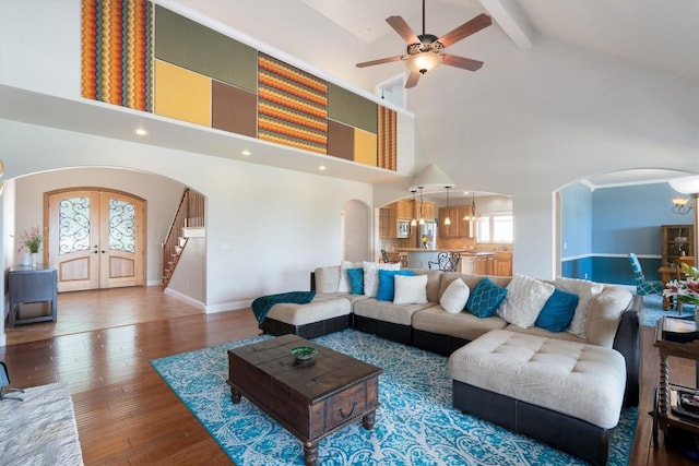 living room featuring french doors, wood-type flooring, beam ceiling, and high vaulted ceiling