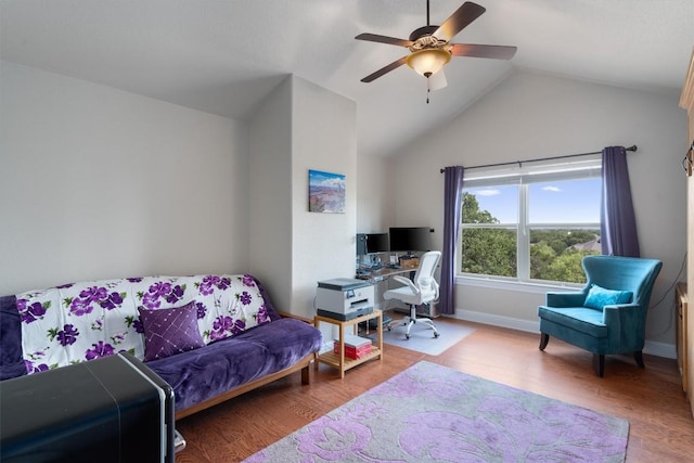 home office featuring vaulted ceiling, ceiling fan, and light hardwood / wood-style floors