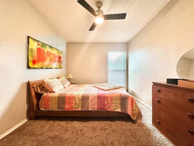 carpeted bedroom with a textured ceiling and ceiling fan