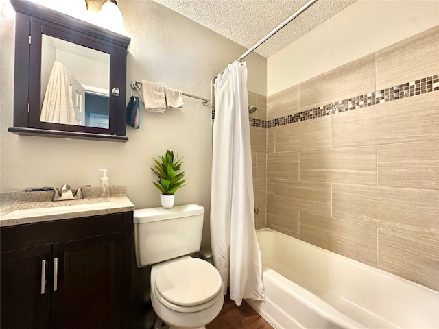 full bathroom with toilet, a textured ceiling, hardwood / wood-style floors, shower / tub combo, and vanity