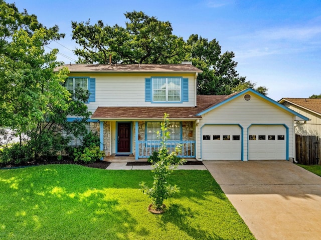 view of property featuring covered porch, a garage, and a front yard