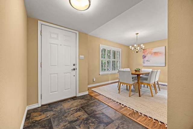 dining room with vaulted ceiling and an inviting chandelier