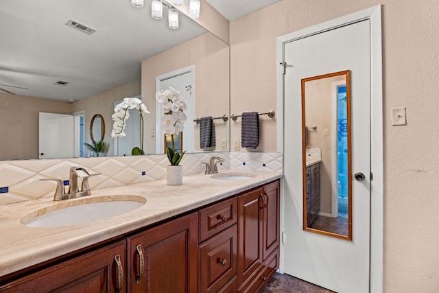 bathroom with vanity, backsplash, and ceiling fan