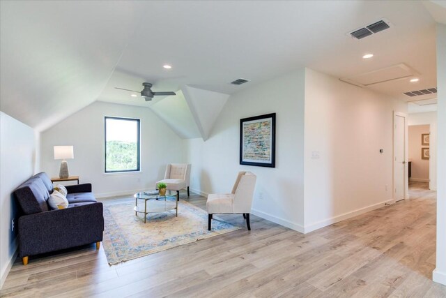 living area featuring lofted ceiling, ceiling fan, and light wood-type flooring