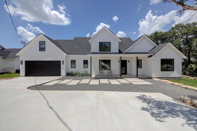14208 Fort Smith Trl, Austin, TX 78734 - modern farmhouse featuring stucco siding, a garage, covered porch, and roof with shingles