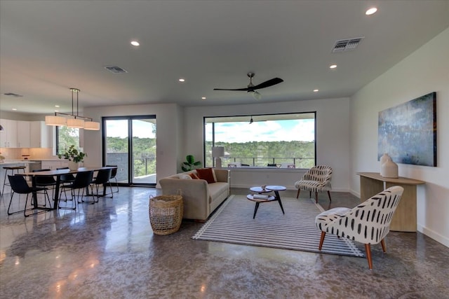 living room featuring recessed lighting, visible vents, ceiling fan, and baseboards