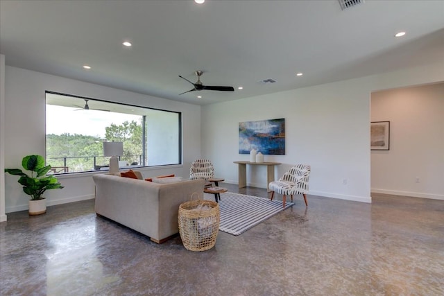 living area with visible vents, baseboards, concrete flooring, and recessed lighting