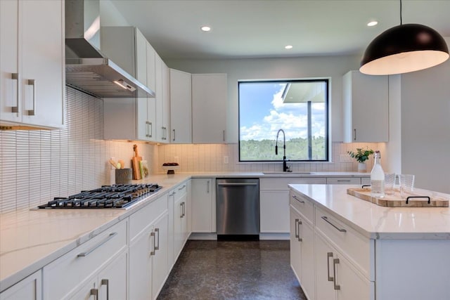 kitchen with appliances with stainless steel finishes, wall chimney range hood, granite finish floor, a sink, and recessed lighting