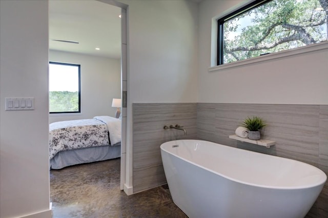 14208 Fort Smith Trl, Austin, TX 78734 - ensuite bathroom with a soaking tub, healthy amount of natural light, tile walls, and recessed lighting