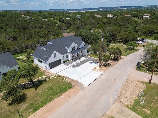 birds eye view of property with a wooded view