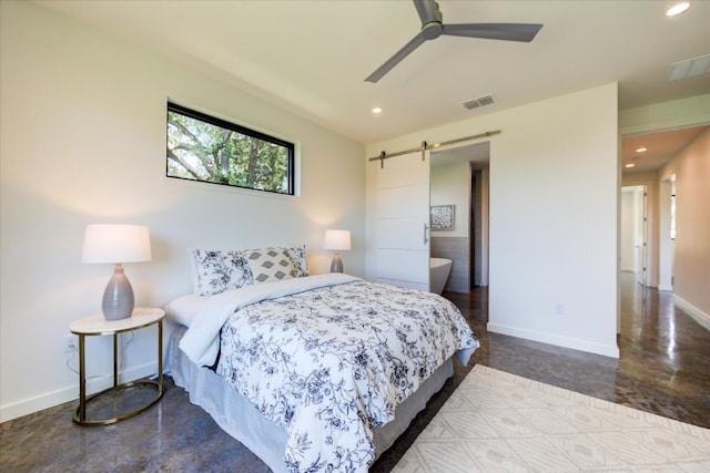 bedroom featuring ceiling fan, a barn door, and concrete flooring