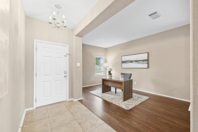 foyer featuring an inviting chandelier and light tile patterned flooring