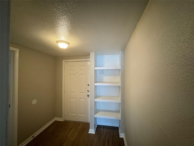 101 S Lockhart St, Manor, TX 78653 - interior space featuring dark wood-style flooring, baseboards, and a textured ceiling