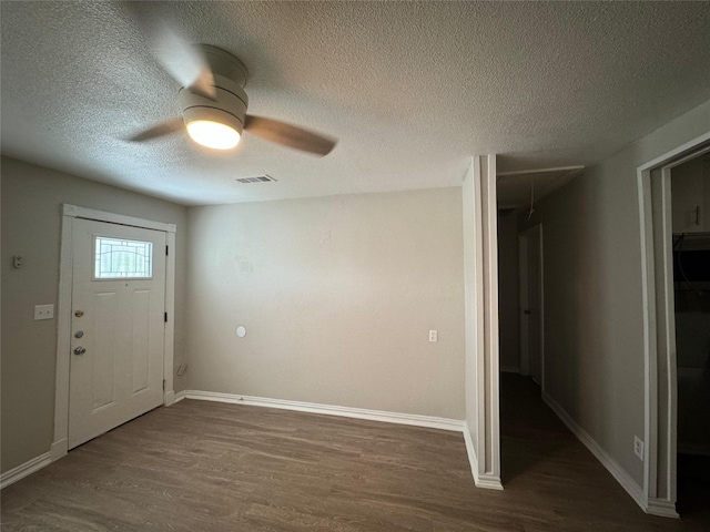 101 S Lockhart St, Manor, TX 78653 - entryway featuring a textured ceiling, ceiling fan, wood finished floors, and visible vents
