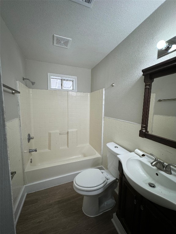 101 S Lockhart St, Manor, TX 78653 - bathroom with visible vents, bathtub / shower combination, wood finished floors, vanity, and toilet