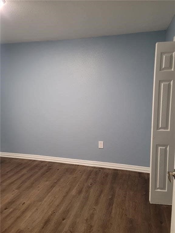 101 S Lockhart St, Manor, TX 78653 - spare room with baseboards and wood finished floors
