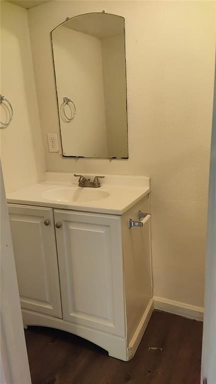 101 S Lockhart St, Manor, TX 78653 - bathroom with baseboards, wood finished floors, and vanity