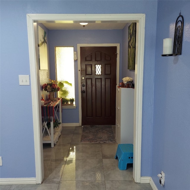 foyer entrance with tile flooring