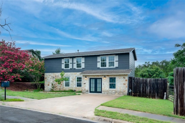 view of front of property featuring a front lawn and french doors