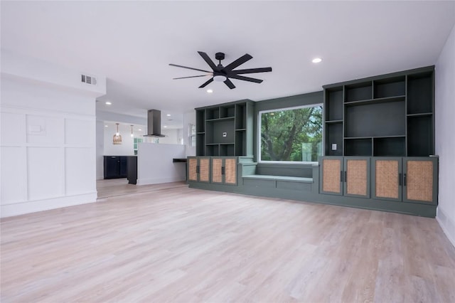 unfurnished living room with ceiling fan and light wood-type flooring