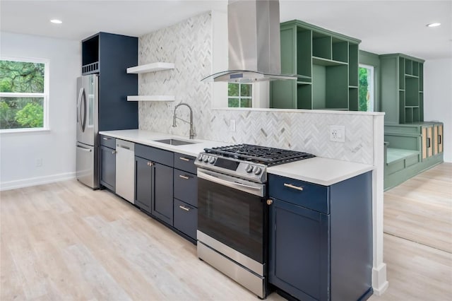 kitchen featuring exhaust hood, sink, light hardwood / wood-style flooring, decorative backsplash, and appliances with stainless steel finishes