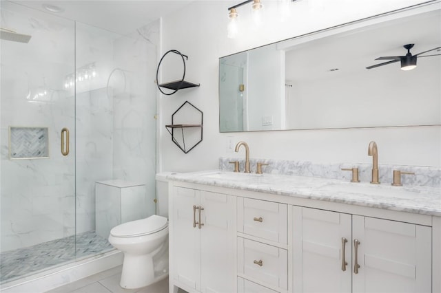 bathroom featuring ceiling fan, tile patterned flooring, toilet, a shower with door, and vanity