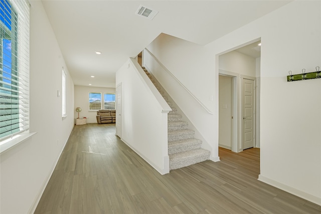 hallway with light hardwood / wood-style floors