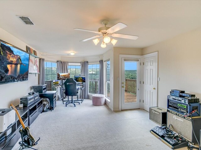 carpeted office featuring ceiling fan