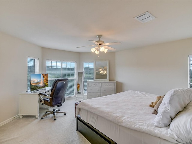 bedroom with ceiling fan and light carpet