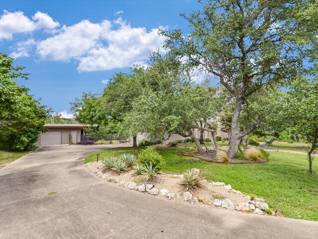 view of front of property featuring a garage and a front yard