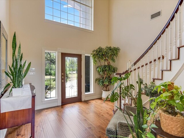 foyer featuring hardwood / wood-style floors and a towering ceiling