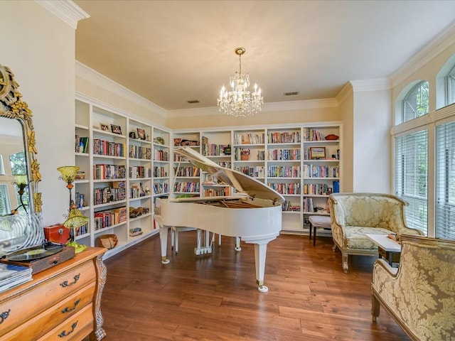 sitting room featuring ornamental molding, dark wood-type flooring, and a chandelier