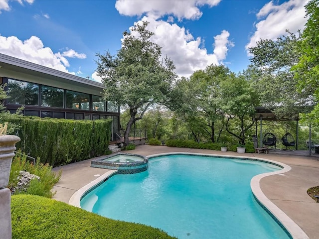 view of swimming pool with an in ground hot tub and a patio area