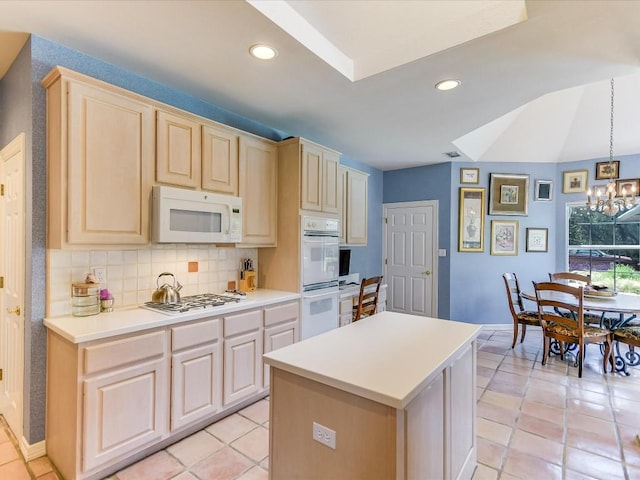 kitchen featuring a center island, decorative light fixtures, a notable chandelier, backsplash, and white appliances