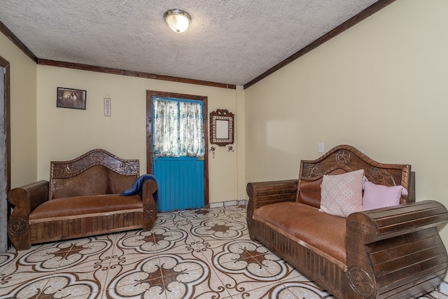 sitting room featuring ornamental molding and a textured ceiling