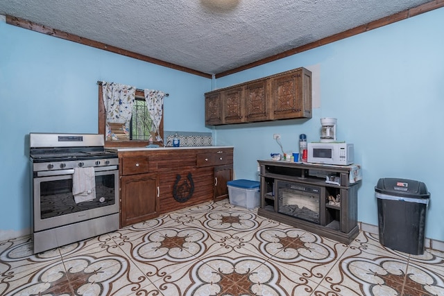 kitchen with stainless steel gas stove, a textured ceiling, ornamental molding, and dark brown cabinets