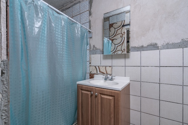 bathroom with tile walls and vanity