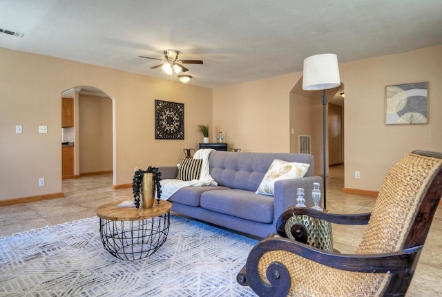 living room featuring light tile patterned floors and ceiling fan