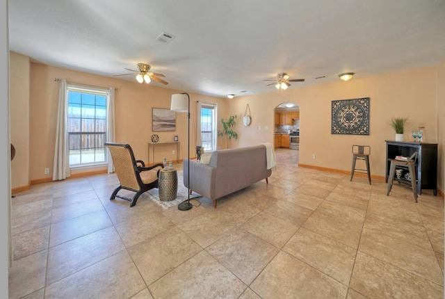 living room with ceiling fan and light tile patterned floors