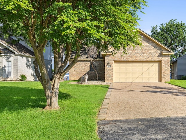 view of front of home featuring a front yard and a garage