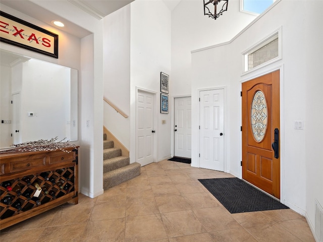 tiled entryway with a high ceiling