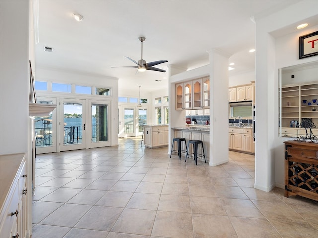 living room featuring plenty of natural light, ceiling fan, and light tile flooring