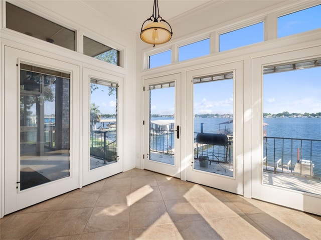 entryway featuring a water view, crown molding, tile patterned flooring, and french doors