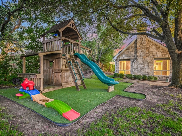 view of jungle gym featuring a lawn