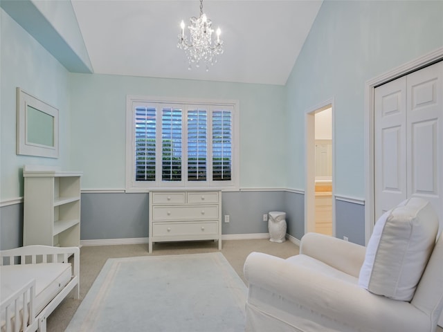 carpeted bedroom featuring a crib, a closet, a chandelier, and vaulted ceiling