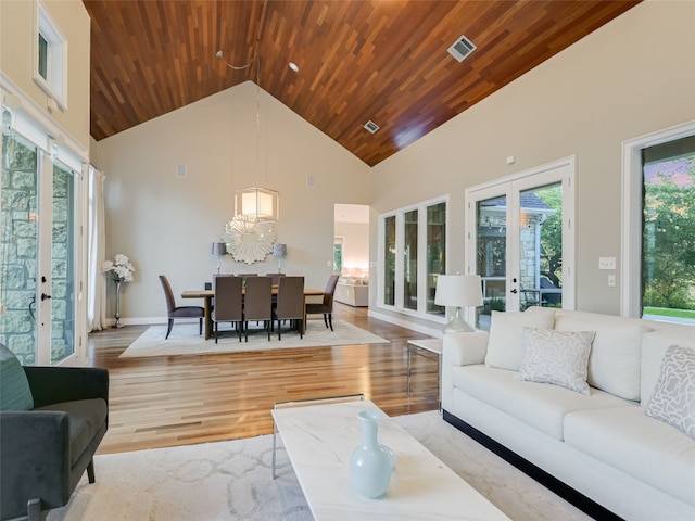 living room with light wood-type flooring, wood ceiling, high vaulted ceiling, and french doors