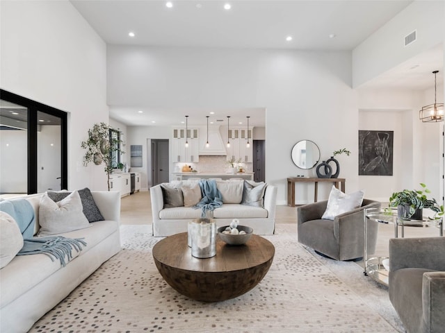 living room featuring a high ceiling and a notable chandelier