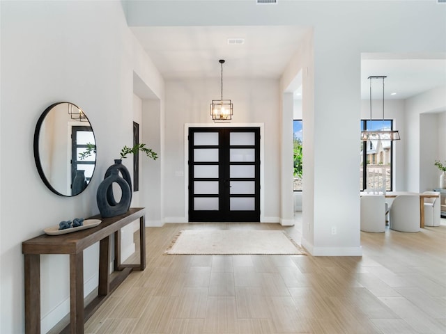 entryway featuring a notable chandelier